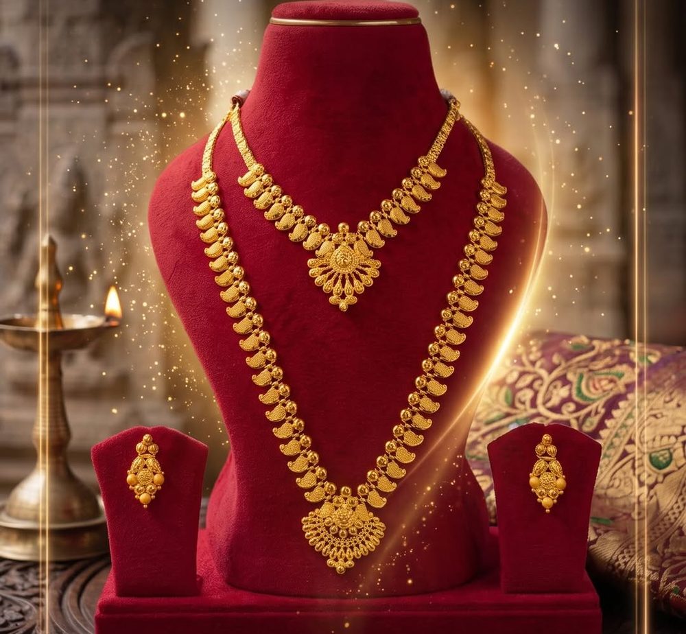 A complete 22K gold bridal set — short necklace, long haram and earrings — displayed on red velvet
