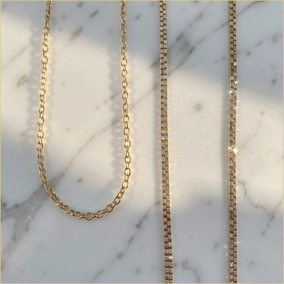 Fine gold chains laid on marble